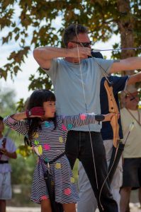 Wyla and her dad practice archery together. Photo courtesy of Pasadena Roving Archers.