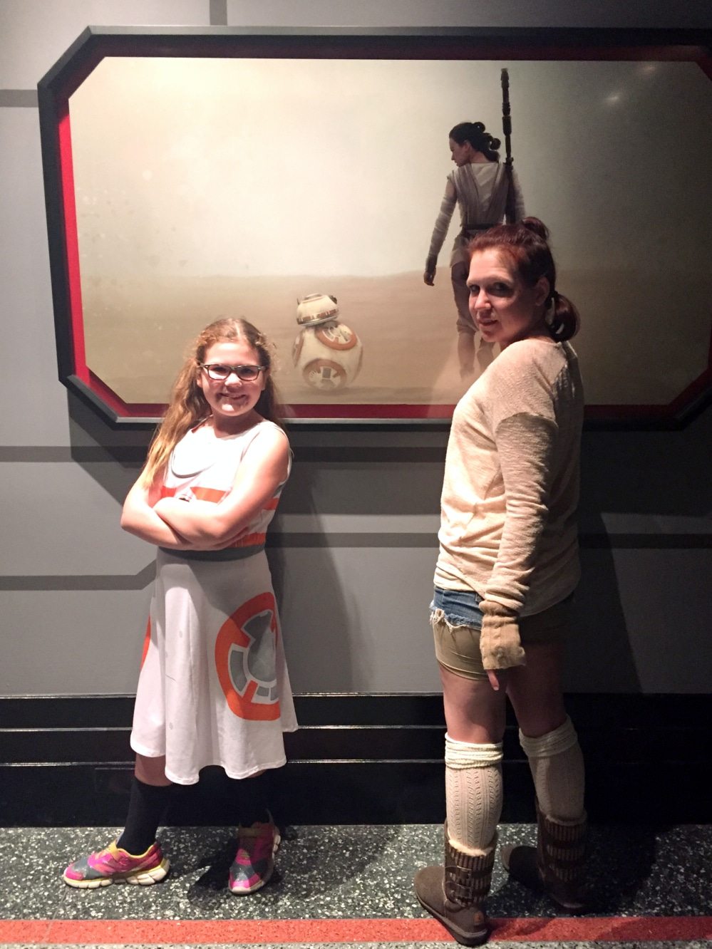 photo of Aeris and Anika with a poster of BB-8 and Rey
