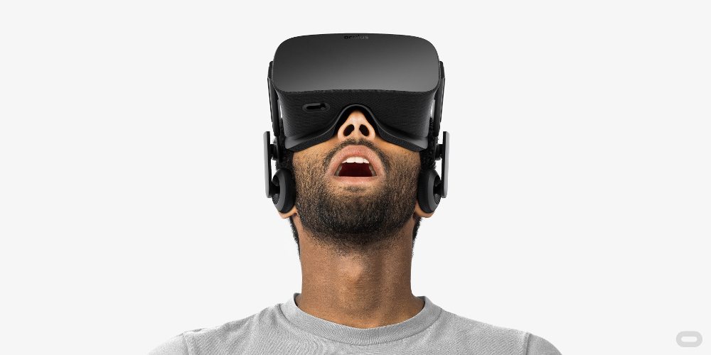 Bearded man looks up with his mouth open wearing a VR headset.