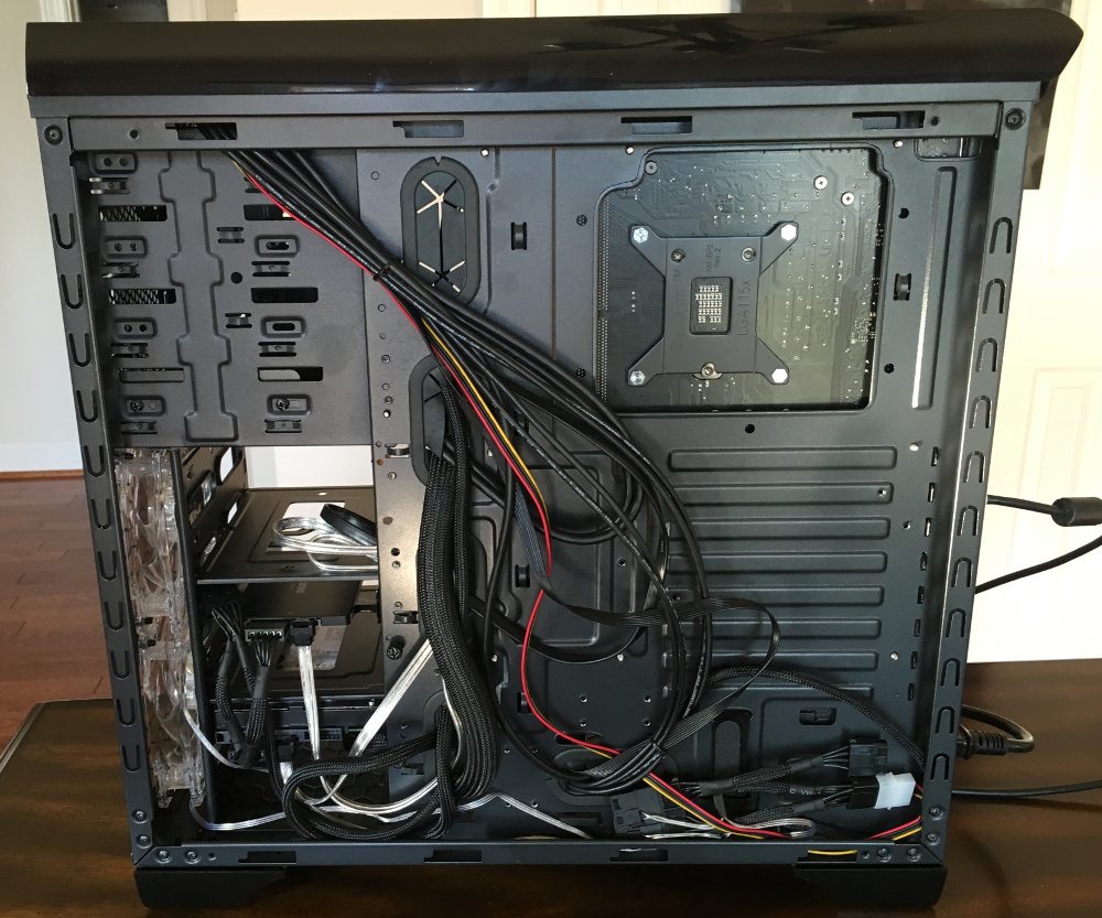 The back of a PC tower with cables routed haphazardly.