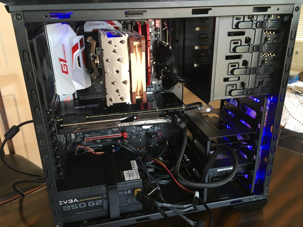 Motherboard and video card installed in a PC tower, with cables everywhere.