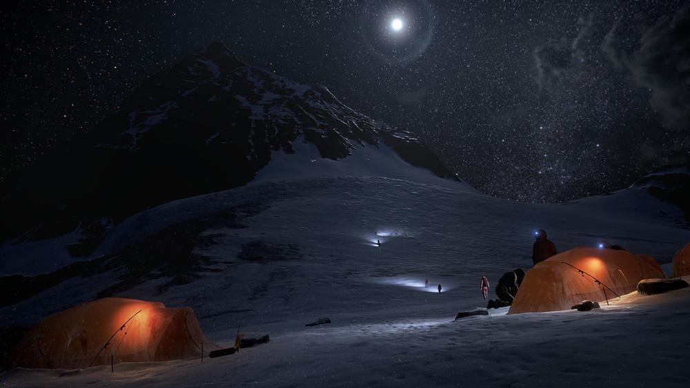 A snow field at night, climbers ascending the mountain in 'Everest VR', their lights illuminating sections of the snow.