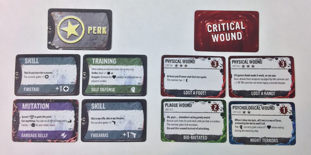A close-up of four perk cards and four critical wound cards.