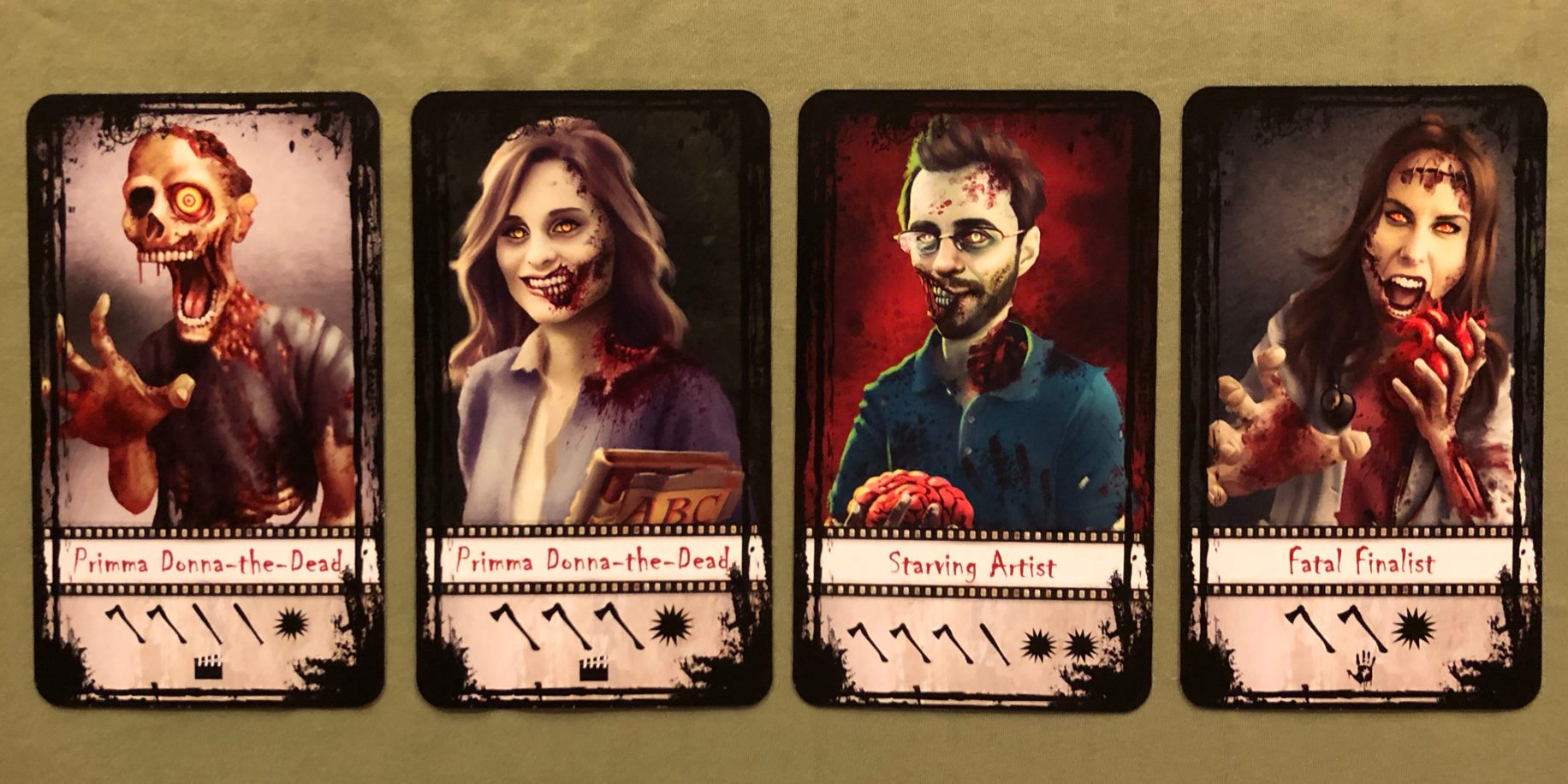 A collection of four Z-lebrity cards from 'Adventures in Zombiewood'