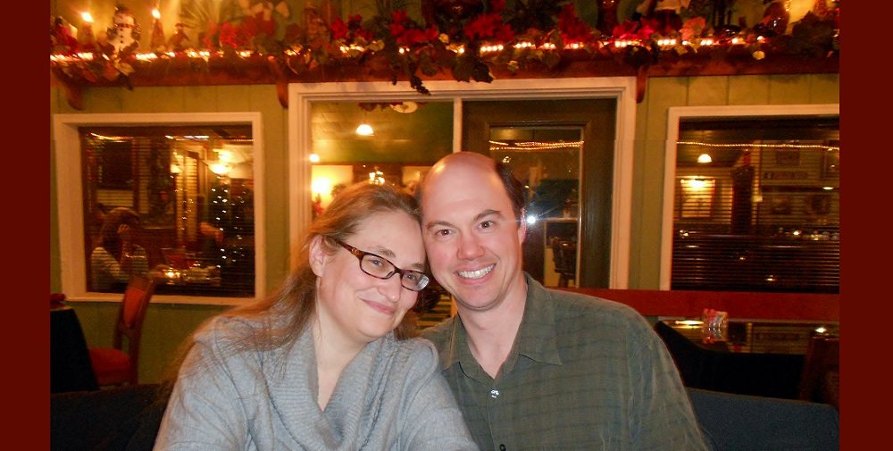 Author and husband in a Christmas-decorated romantic restaurant