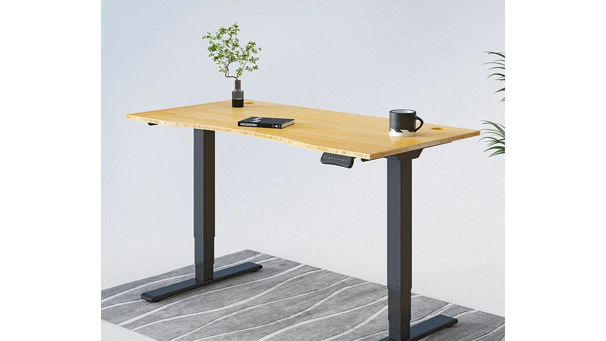 An adjustable-height sit or stand desk with a back frame and a brown surface.